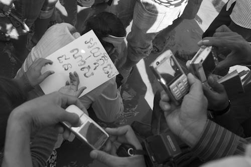 CAMBODIA. Phnom Penh. 1/12/2011: Boeung Kak lake residents writing messages with their own blood after press conference, some saying 'I defend my home and they treat me like a criminal'.