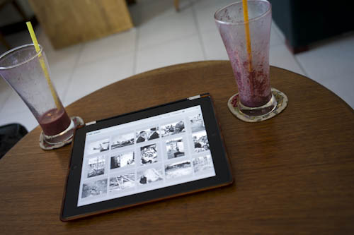 CAMBODIA. Phnom Penh. 22/01/2012: Working on The Quest with a Blueberry berry smoothie at Java Café.