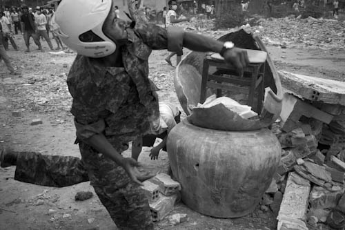 CAMBODIA. Phnom Penh. 3/01/2012: Residents throwing stones at police before final eviction of the Borei Keila community.