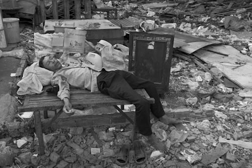 CAMBODIA. Phnom Penh. 3/01/2012: Resident taking a nap when collecting goods from their destroyed houses during final eviction of the Borei Keila community.