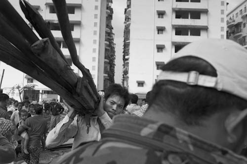 CAMBODIA. Phnom Penh. 4/01/2012: Carrying timber from destroyed houses the day after the final eviction of the Borei Keila community.