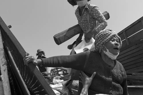 CAMBODIA. Phnom Da, Oudong (Kandal). 5/01/2012:  Evicted from Borei Keila unloading from truck at relocation site for 120 families. Each family is supposed to receive a plot of land of 5x12 meter and 125$ as a compensation.