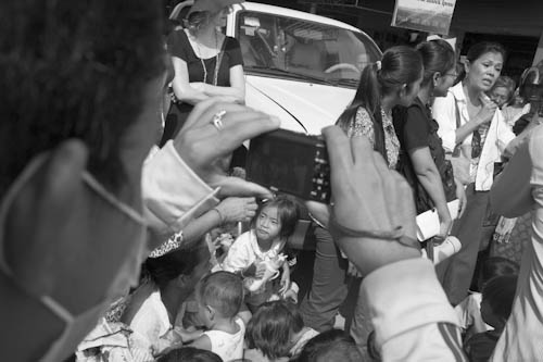 CAMBODIA. Phnom Penh. 29/02/2012: SENG Theary, head of NGO Civicus, distributing school material collected by a U.S. middle school to children of evicted Borei Keila residents.