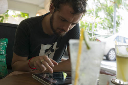 CAMBODIA. Phnom Penh. 26/04/2012: Chris Kelly, Documentary Filmmaker, author of 'The Cause of Progress', testing 'Quest for Land' on my iPad.