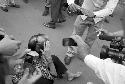 CAMBODIA. Phnom Penh. 21/04/2011: Press documenting Boeung Kak Lake resident under threat of an eviction hit by police during scuffle at demonstration in front of City Hall.