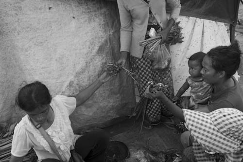 CAMBODIA. Phnom Bat (Kandal). 7/06/2012: Buying vegetables at settlement of people evicted from Borei Keila, 40 Km away from Phnom Penh.