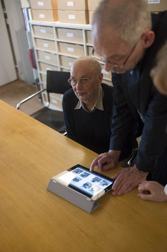 FRANCE. Paris. 26/06/2012: Robert Delpire, Publisher, and Michel Christolhomme, Director of the 'Fait & Cause gallery in Paris, looking at 'Quest for Land' for the iPad.