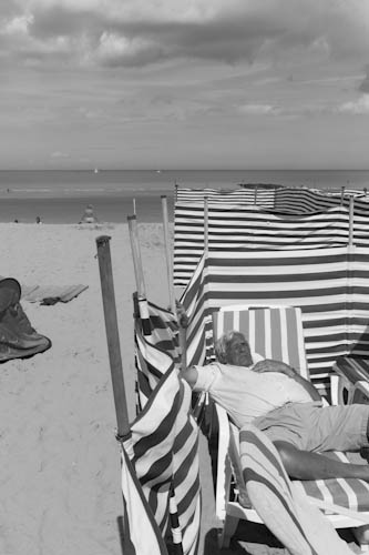 BELGIUM. Westende (West Vlaanderen). 5/08/2012: Nap on beach at seaside resort.
