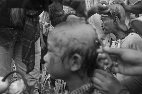 CAMBODIA. Phnom Penh. 25/09/2012: Sons of Tim Sakhmony and Yorm Bopha shaving their hair in front of the Municipal Court to plead for the release of their imprisoned mothers.