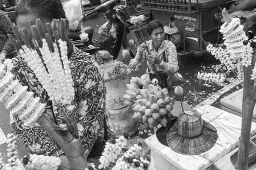 CAMBODIA. Phnom Penh. 7/10/2012: Selling flowers to worshippers during Pchum Ben celebrations at Wat Lanka.