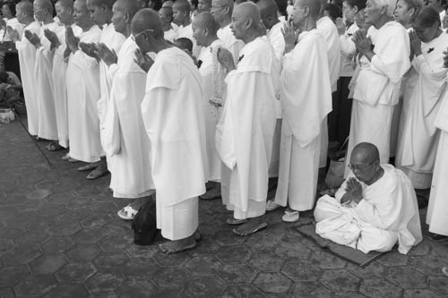 CAMBODIA. Phnom Penh. 19/10/2012: Nuns praying while paying tribute to King Norodom Sihanouk in front of the Royal Palace.