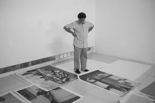 CAMBODIA. Phnom Penh. 3/12/2012: Christian Caujolle, Curator, mounting the 5-year retrospective of Phnom Penh Photo, gathering new work of 75 photographers exhibited over the years.