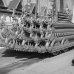 CAMBODIA. Phnom Penh. 2/02/2013: Souvenir photographs in front of the carts used in the procession to carry late King Norodom Sihanouk's coffin from the Royal Palace to the funeral pyre.