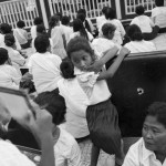 CAMBODIA. Phnom Penh. 3/02/2013: Crowd praying and trying to catch a glimpse of the ongoings at the 'Veal Meru' or cremation ground during the funeral of the late King Norodom Sihanouk.