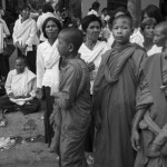 CAMBODIA. Phnom Penh. 3/02/2013: Woman meditating amidst the crowd in front of the 'Veal Meru' or cremation ground during the funeral of the late King Norodom Sihanouk.