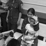 CAMBODIA. Phnom Penh. 27/03/2013: Yorm Bopha reunited with her son during a recess while her supporters from Boeung Kak Lake demonstrate at the gate of the Supreme Court, moments before her request for bail was yet again denied.
