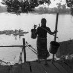 CAMBODIA. Sre Kor (Stung Treng). 27/02/2013: Evening water chore at the Sesan river. The village will be submerged by the water from the Sesan2 reservoir.