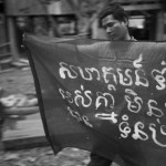 CAMBODIA. Sre Kor (Stung Treng). 27/02/2013: Member of the indigenous Tampuon community preparing banners for a demonstration planned the next day to protest against the construction of the Sesan2 dam. The dam will flood their village, forcing them to relocate.