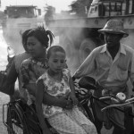 MYANMAR, Yangon. 25/04/2013: Family in a rickshaw near the ferry, close to Strands Hotel.