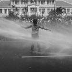 CAMBODIA, Phnom Penh. 29/05/2013: Tep Vanny, Boeung Kak Lake representative, sprayed by the water cannons of fire trucks during a demonstration in front of the Municipality Building, blocking Monivong Boulevard.
