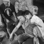 MYANMAR, city of Tachileik (Shan State). 3/05/2013: Akha relatives at the funeral of Bou Deu, the 43 year old Akha wife of a mason who migrated from his village near Ksieng Tong to the city of Tachileik 20 years ago.