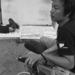 CAMBODIA, Phnom Penh. 3/06/2013: The son of Yorm Bopha sleeping on a protest poster on the morning after Boeung Kak Lake representatives Tep Vanny, Bov Sopheak, Kung Chhantha and Bo Chorvy, spent the night on a 24h hunger strike in front of the Appeals Court to ask for justice for Yorm Bopha, jailed land activist and Amnesty International Prisoner of Conscience.