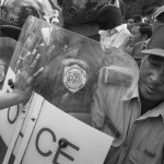 CAMBODIA. Phnom Penh. 2/07/2013: Members of the Boeung Kak Lake community, entagled in a land issue since 2007, try to push past a Police blockade preventing them from demonstrating in front of Prime Minister Hun Sen's house on Sihanouk Boulevard.