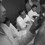 CAMBODIA. Phnom Penh. 29/08/2013: Yim Sovann, MP, Sam Rainsy, President of the CNRP reflected in a tablet, and Kuy Bunroeun, deputy chief of CNRP’s administration department, at a press conference at the opposition CNRP HQ regarding alleged frauds during the 2013 parliamentary elections which saw a large shift in seats from the CPP to the CNRP.