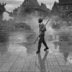 CAMBODIA. Phnom Penh. 15/09/2013: Defiant CNRP supporter amidst tear gas after having torn down a barbed wire barricade on first day of a planned 3-day protest by the opposition CNRP to fight the results of the 2013 legislative elections which, according to the CNRP, were wrought with fraud and saw the ruling CPP lose a considerable number of seats to the CNRP while officially still maintaining a small majority.