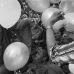 CAMBODIA. Phnom Penh. 17/09/2013: Monks receiving balloons during the third and last day of a mass demonstration at Freedom Park by the opposition CNRP to dispute the 2013 legislative elections.