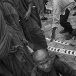 CAMBODIA. Phnom Penh. 6/10/2013: Monks supporting the opposition CNRP are helped in a reserved area when attending a 'public forum' at 'Freedom Place', two weeks after the CNRP boycotted the opening ceremony of the 2013 legislature.