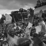 CAMBODIA. Phnom Penh. 6/10/2013: Opposition CNRP supporters shelter from the rain when attending a 'public forum' at 'Freedom Place', two weeks after the CNRP boycotted the opening ceremony of the 2013 legislature.