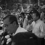 CAMBODIA. Phnom Penh. 23/10/2013: Kem Sokha, CNRP co-President, flanked by Sam Rainsy, CNRP co-President, addressing the crowd on the first of a 3 day demonstration by the opposition CNRP to protest the 2013 legislative elections results and to demand an implementation of the 1991 Paris Peace Accords.