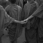 CAMBODIA. Phnom Penh. 23/10/2013: Monks from Kampuchea Krom holding hands during a march to deliver a petition of 2 million signatures to the UN Human Rights office on the first of a 3 day demonstration by the opposition CNRP to protest the 2013 legislative elections results and to demand an implementation of the 1991 Paris Peace Accords.