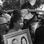 CAMBODIA. Phnom Penh. 21/10/2013: SL Garment factory workers carrying a portrait of Prime Miniser Hin Sen and his wife Bun Rany, and locked in a labour conflict with their direction for several weeks, demonstrate in front of Prime Minister Hun Sen's house near Independence Monument.