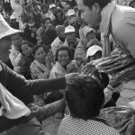 CAMBODIA. Phnom Penh. 19/12/2013: T-shirt distribution to villagers having spent their 3rd night at Freedom Place during a CNRP opposition demonstration requesting reelections.