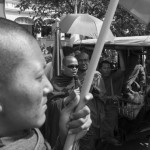 CAMBODIA. Phnom Penh. 24/12/2013: Monk, flanked by But Bunthen, Human Rights Activist, addressing the Phnom Penh Governor in Vietnamese when monks of the Independent Monks Network demonstrate in front of the Municipality to demand excuses for the violence police used upon them the previous day.