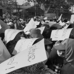 CAMBODIA. Phnom Penh. 24/12/2013: FActory workers carrying signs reading 'Hun Sen must step down' at Freedom Park.