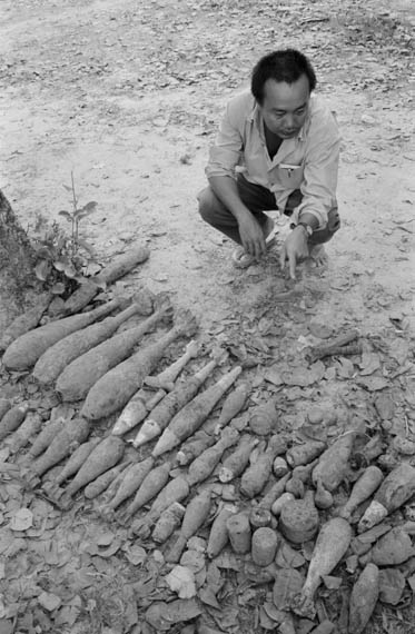 CAMBODIA. Svay Rieng. 19/03/1999: Mr Rithy Panh, film director, during shooting of a documentary film about the installation of an optic fiber cable from Alcatel, crossing the whole of Cambodia and part of a Mekong network for data and telecommunications. UXO and mines cleared by army demining unit on site of cable.