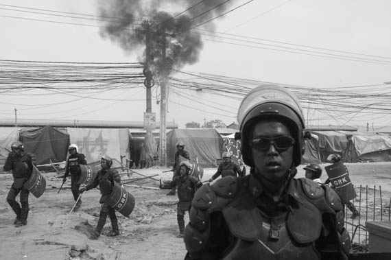 CAMBODIA. Phnom Penh.3/01/2014: Armed forces confronting striking workers who pulled up barricades on Veng Sreng road will leave behind at least 3 dead, one badly injured and 3 confirmed arrests.