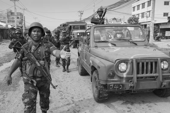 CAMBODIA. Phnom Penh.4/01/2014: Arrival of heavily armed military to replace the Gendarmerie after the violent crackdown on garment workers strike of the day before at Veng Sreng road in the industrial area of Phnom Penh.