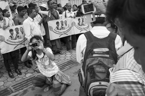 CAMBODIA. Phnom Penh. 13/01/2014: South Korean member of Amnesty International monitoring some 80 workers' unions representatives, monks and activists gathered in front of the UNHCHR to deliver a petition requesting the liberation of 23 workers, activists and union leaders who were arrested during the violent crackdowns on striking workers of January 2nd and 3rd.