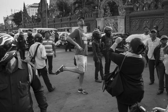 CAMBODIA. Phnom Penh. 19/01/2014: Naly Pilorge, director of the Cambodian League for the Promotion and Defence of Human Rights (Licadho), photographing an activist before being prevented by helmeted municipality thugs to hold a demonstration requesting the release of 23 people arrested on January 2nd and 3d during a violent crackdown on striking workers.