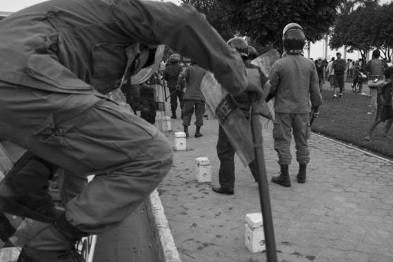 CAMBODIA. Phnom Penh. 19/01/2014: Riot police arriving on sit where activists from IDEA and other human rights organisations were prevented by helmeted municipality thugs to hold a demonstration requesting the release of 23 people arrested on January 2nd and 3d during a violent crackdown on striking workers.