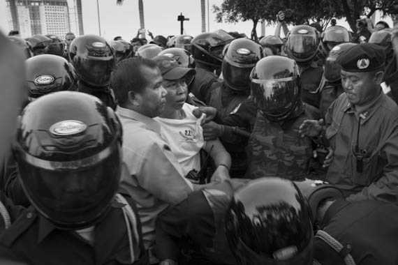 CAMBODIA. Phnom Penh. 19/01/2014: Sok Chun Oeun, Deputy Director of IDEA arrested when activists from IDEA and other human rights organisations were prevented by helmeted municipality thugs to hold a demonstration requesting the release of 23 people arrested on January 2nd and 3d during a violent crackdown on striking workers.