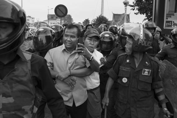 CAMBODIA. Phnom Penh. 19/01/2014: Sok Chun Oeun, Deputy Director of IDEA, arrested when activists from IDEA and other human rights organisations were prevented by helmeted municipality thugs to hold a demonstration requesting the release of 23 people arrested on January 2nd and 3d during a violent crackdown on striking workers.