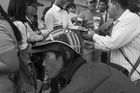 CAMBODIA. Phnom Penh. 29/01/2014: A group of citizens representing nearly 200 NGO's and organisations, distributing a press release before touring several embassies to deliver a petition requesting the liberation of 23 people arrested and jailed during the January 2nd and 3d violent crackdown on a garment worker's strike.