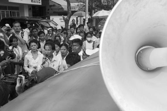 CAMBODIA. Phnom Penh. 22/01/2014: Chea Mony and Seng Theary while leading a march for the 10th commemoration of the assassination of union leader Chea Vichea, when a small crowd, led by Chea Mony, Union Leader and Chea Vichea's brother, Sam Rainsy and Kem Sokha, opposition CNRP Co-Presidents, marched from the FUTWC office to the statue of Chea Vichea.