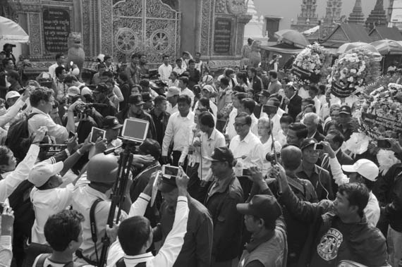 CAMBODIA. Phnom Penh. 22/01/2014: For the 10th commemoration of the assassination of union leader Chea Vichea, a small crowd, led by Chea Mony, Union Leader and Chea Vichea's brother, Sam Rainsy and Kem Sokha, opposition CNRP Co-Presidents, marched from the FUTWC office to the statue of Chea Vichea.