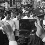 CAMBODIA. Phnom Penh. 22/01/2014: For the 10th commemoration of the assassination of union leader Chea Vichea, a small crowd, led by Chea Mony, Union Leader and Chea Vichea's brother, Sam Rainsy and Kem Sokha, opposition CNRP Co-Presidents, marched from the FUTWC office to the statue of Chea Vichea.